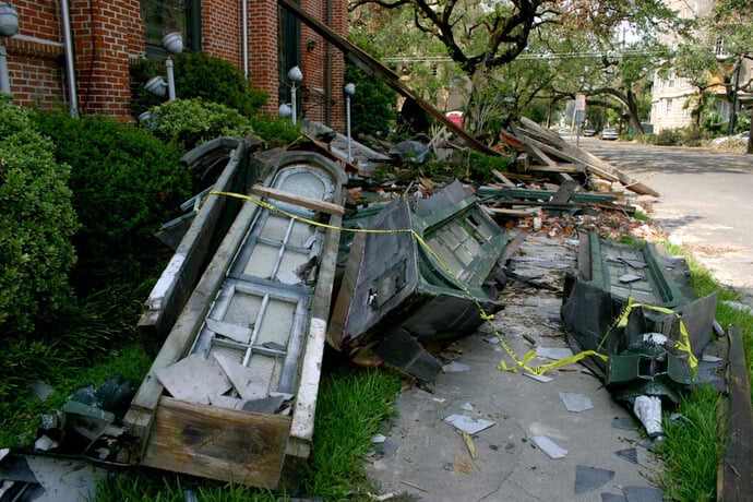 Rubble from windows, parts of the bell tower and the steeple litter the sidewalk in front of Rayne United Methodist Church in 2005 following Hurricane Katrina. Photo courtesy of the Rev. Callie Winn Crawford.