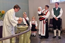 Bishop Knut Refsdal, who leads the Nordic-Baltic-Ukraine Area, baptizes Aksel, as the baby’s parents, Håkon and Astri Helen Madland, look on. The newly elected bishop chose Flekkefjord, Norway, as his first visit in a strong sign of solidarity with the United Methodists there. Photo by Karl Anders Ellingsen, UM News. Bishop Knut Refsdal, who leads the Nordic-Baltic-Ukraine Area, baptizes Aksel, as the baby’s parents, Håkon and Astri Helen Madland, look on. The newly elected bishop chose Flekkefjord, Norway, as his first visit in a strong sign of solidarity with the United Methodists there. Photo by Karl Anders Ellingsen, UM News.