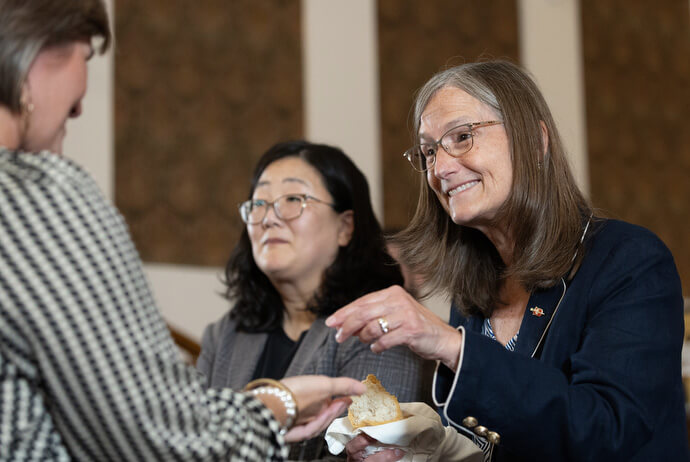 Bishop Sandra Steiner Ball (right) and the Rev. Prumeh Lee serve Holy Communion during opening worship for the United Methodist Deacons Gathering at the Upper Room Chapel in Nashville, Tenn. Lee is a provisional deacon in The United Methodist Church and serves as secretary for the New York Annual Conference. Photo by Mike DuBose, UM News.