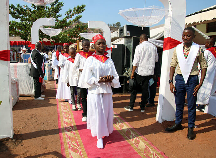 Young members of The United Methodist Church participate in the procession during the installation ceremony for Bishop Nelson Kalombo Ngoy in Kalemie, Congo. The local youth president, Ruphin Monganzobu, said the community was hopeful that Ngoy would guide them like a “good father” into the future. Photo by Chadrack Tambwe Londe, UM News.