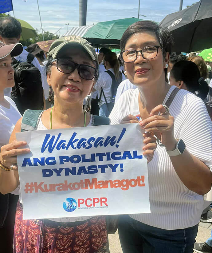 United Methodist Deaconess Norma P. Dollaga (left) and the Rev. Lizette Tapia-Raquel, dean of Union Theological Seminary, hold a sign that reads, “Terminate the political dynasty! Take responsibility” during a Sept. 21 protest rally in the Philippines. Photo courtesy of the Rev. Lizette Tapia-Raquel.