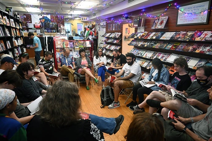 Members of the Comics X Theology book club discuss the graphic novel “Persepolis” on Aug. 31 at Fantom Comics in Washington, D.C. Organized by a United Methodist pastor, the book club meets once a month to discuss a comic and how its story relates to religious issues. Photo by Jim Patterson, UM News. Members of the Comics X Theology book club discuss the graphic novel “Persepolis” on Aug. 31 at Fantom Comics in Washington, D.C. Organized by a United Methodist pastor, the book club meets once a month to discuss a comic and how its story relates to religious issues. Photo by Jim Patterson, UM News.