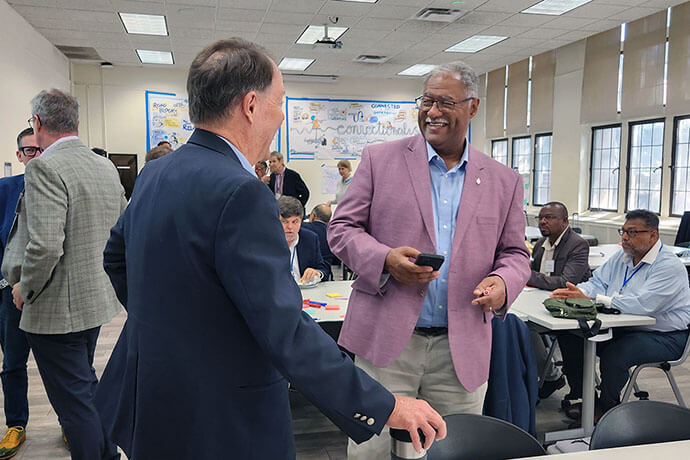 Jaydee Hansen, policy director at the Center for Food Safety, chats with Bishop Julius Trimble, top executive at United Methodist Board of Church and Society, during a break in talks during a summit called by Wespath Benefits and Investments to discuss its investment parameters. Photo courtesy Wespath Benefits and Investments.