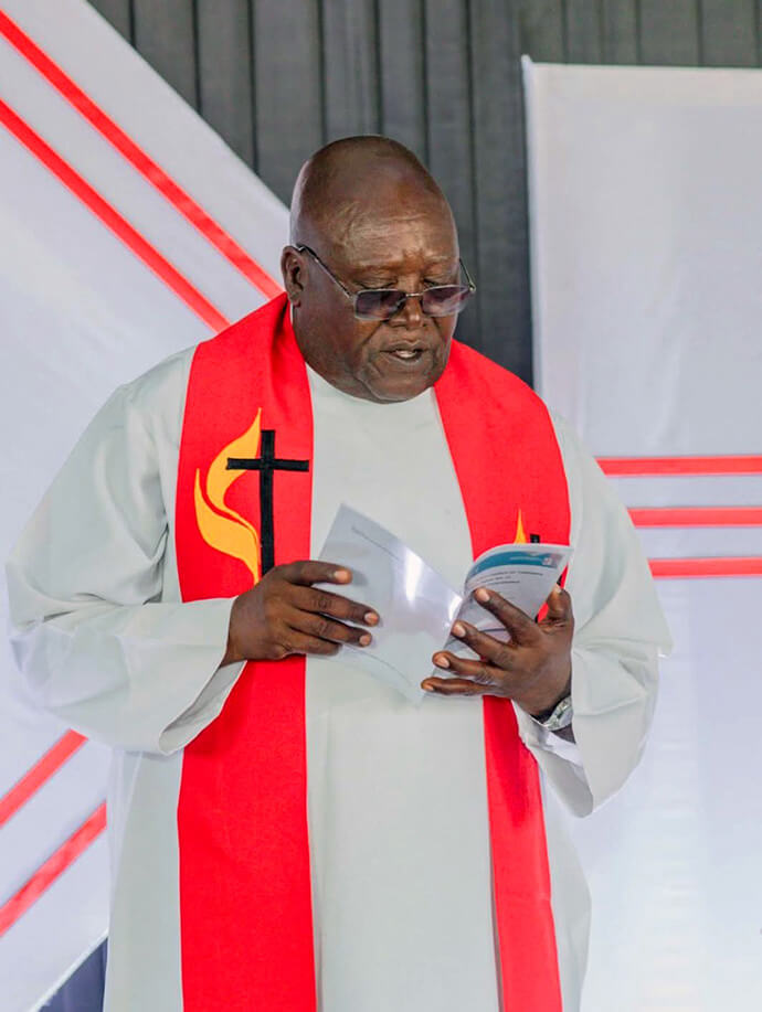 The Rev. Abisay Lameck Juwakali wears his vestments during a religious service. Juwakali, who was the director of the Sebring Mwanza Mission Center, was a driving force behind the integration of spiritual growth with educational and health development. Photo Facebook Page courtesy of Julio Bolila.