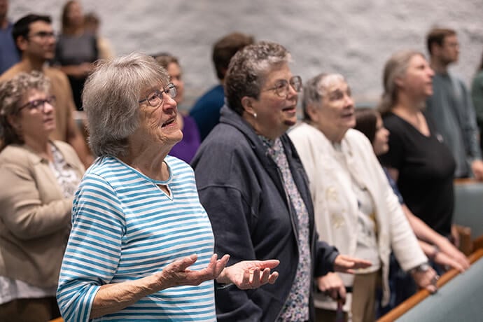 Irene Weesner (left front) joins in singing during worship at Elkhart Faith United Methodist Church. Weesner served as a volunteer with the church’s youth group when Frank Beard, now a bishop, was a youth. Photo by Mike DuBose, UM News.