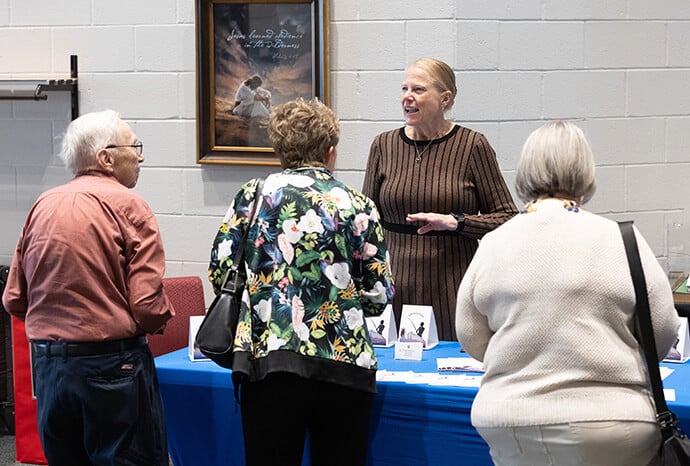 Melissa Beard answers questions about Catching Like Jesus Ministries between services at Elkhart Faith United Methodist Church. Beard and her husband, Bishop Frank Beard, are founders of the new United Methodist evangelism ministry. Photo by Mike DuBose, UM News.