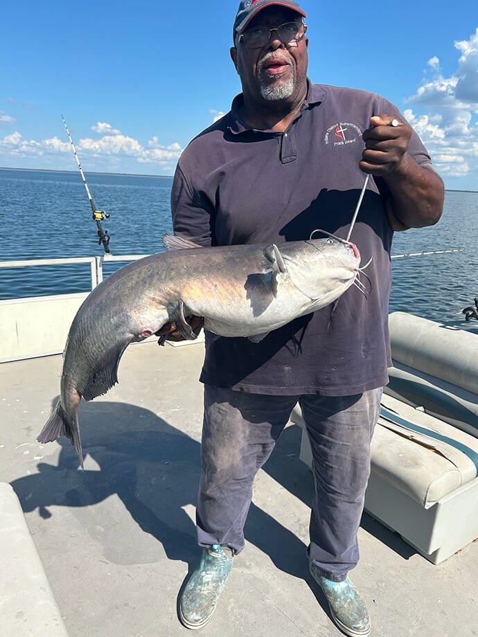 Bishop Frank Beard, an avid fisherman, stands with a catfish he recently caught in South Carolina. Photo courtesy of Bishop Frank Beard.