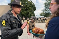 Illinois State Police Lt. Col. Jason Bradley (left) speaks with the Rev. Hannah Kardon, a United Methodist pastor who was among a group of clergy on Oct. 10 asking to bring Holy Communion to detainees in the U.S. Immigration and Customs Enforcement facility in Broadview, near Chicago. The following day another group of clergy also made the same request. Both times Bradley reached out to ICE officials, who denied the clergy entry. Photo by the Rev. Britt Cox, First United Methodist Church in Evanston, Ill. Illinois State Police Lt. Col. Jason Bradley (left) speaks with the Rev. Hannah Kardon, a United Methodist pastor who was among a group of clergy on Oct. 10 asking to bring Holy Communion to detainees in the U.S. Immigration and Customs Enforcement facility in Broadview, near Chicago. The following day another group of clergy also made the same request. Both times Bradley reached out to ICE officials, who denied the clergy entry. Photo by the Rev. Britt Cox, First United Methodist Church in Evanston, Ill.