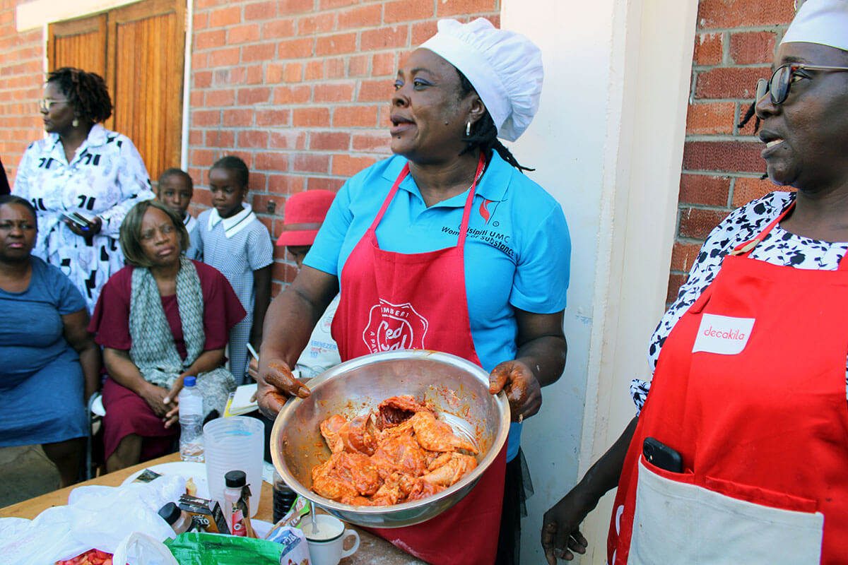 Sandra Kudzika (center) and Franscisca Madondo teach Women of Substance members to prepare relish and bake buns during cooking classes. Members of the organization in Harare, Zimbabwe, are trained in cooking, baking and other skills that promote economic independence and personal empowerment through a partnership with The United Methodist Church’s Indiana Conference. Photo by Kudzai Chingwe, UM News.