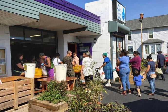 People wait to enter the All People’s Fresh Market, a ministry of United Methodist Church and Community Development for All People in Columbus, Ohio. The market serves an average of 450 people each weekday and gives out more than 3 million pounds of fresh produce every year. Photo courtesy of the Rev. Joelle Henneman, United Methodist Church for All People.