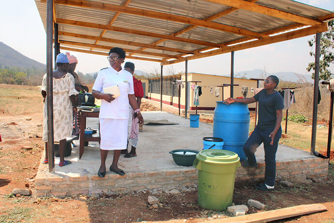 Expectant mothers are served lunch at Old Mutare Mission Hospital in Zimbabwe. Sister Florence Mefor (in white uniform), a Global Ministries missionary and midwife, started the daily meal service after realizing that many women arrived at the church’s mission hospitals with no food and often were malnourished or anemic. Photo by Kudzai Chingwe, UM News.
