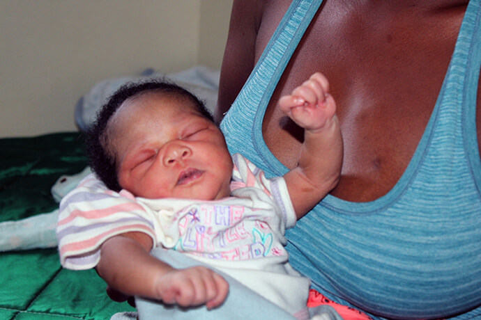 Netsai Makuvaza holds her sixth child, day-old Peace Ruvimbo Dangare, at Old Mutare Mission Hospital in Zimbabwe. Makuvaza says she enjoyed her stay at the church facility. Photo by Kudzai Chingwe, UM News.