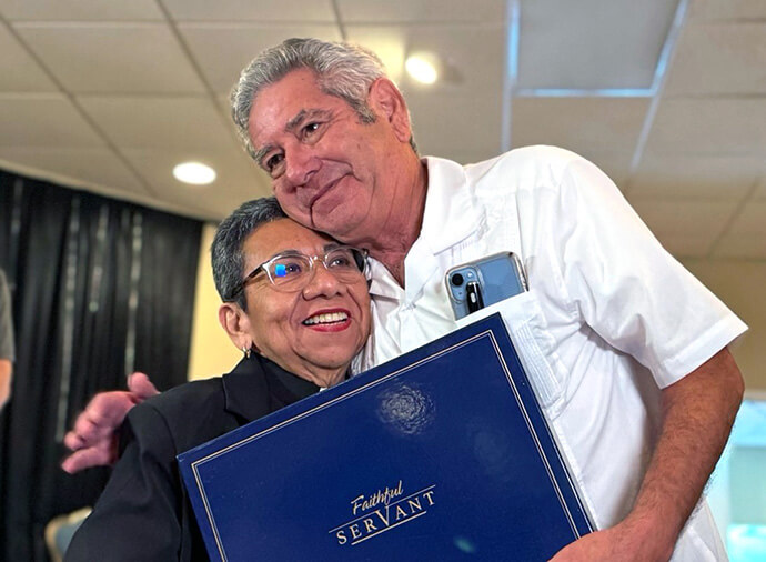 The Rev. Javier Leyva receives a special recognition for his pastoral work from the Rev. Nohemí Ramírez during the 120th anniversary ceremony of La Trinidad United Methodist Church. Photo by the Rev. Gustavo Vasquez, UM News.