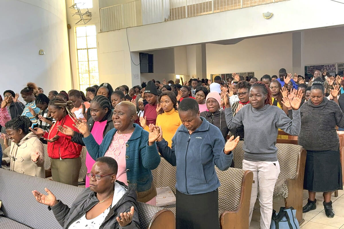 Church members and guests pray together at St. Peter’s Inner City United Methodist Church in Mutare, Zimbabwe, during a recent lunch-hour service. The informal program features popular choruses that appeal to people of different denominations. Photo by Eveline Chikwanah, UM News.