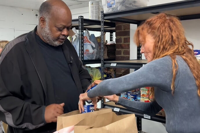 Danny Fisher selects some canned goods at the Rhea House, a free grocery store in Tennessee operated by United Methodist Reelfoot Rural Ministries and Dyersburg First United Methodist Church. Video image by Lilla Marigza, UM News.
