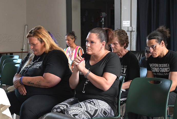 Members of Second Chance pray during services Sept. 21 at Franklinton High School in Columbus, Ohio. The new United Methodist faith community, launched by the Rev. Allyssa Graves, centers itself around recovery from addictions. Graves said the goal of the church plant is “to meet people where they are.” Photo by Jim Patterson, UM News.