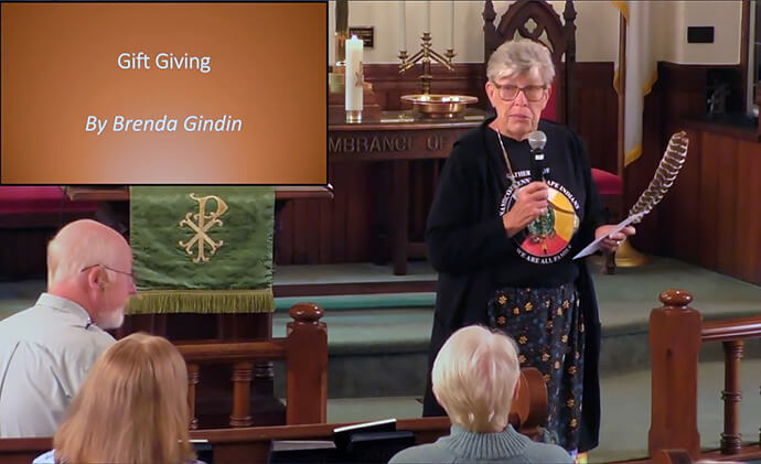 Cynthia Mosley, a Nanticoke Lenni Lenape and longtime leader at St. John United Methodist Church in Bridgeton, N.J., holds the symbolic gift of a turkey feather as she thanks the congregation of Marshallton United Methodist Church for their friendship and support during Marshallton’s Native American Sunday celebration on Oct. 12. Video screenshot courtesy of Marshallton United Methodist Church via YouTube.