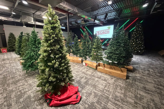 The worship space at Valley Church in Allendale, Michigan has been transformed into an artificial “tree farm.” The United Methodist congregation holds the event every year for families with special needs and families in need. Photo by Lilla Marigza, UM News.