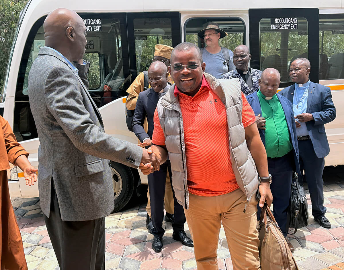 James H. Salley (left), president of Africa University, Inc., and a lay member of the South Carolina Conference, greets men as they arrive at the United Methodist university for a historic first meeting with leaders of United Methodist Men. Photo by Eveline Chikwanah, UM News.
