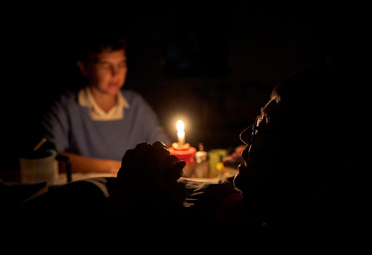 Sister Alegria (right) and Sister Confianza, members of the Amigas del Señor (Women Friends of the Lord) Monastery in Limón, Honduras, pray during evening compline. They moved from their remote monastery to a house in the seaside village because of Sister Alegria's illness, which confines her to a bed. Photo by Paul Jeffrey, UM News.Originally from the United States, the women founded the monastery in 2006.