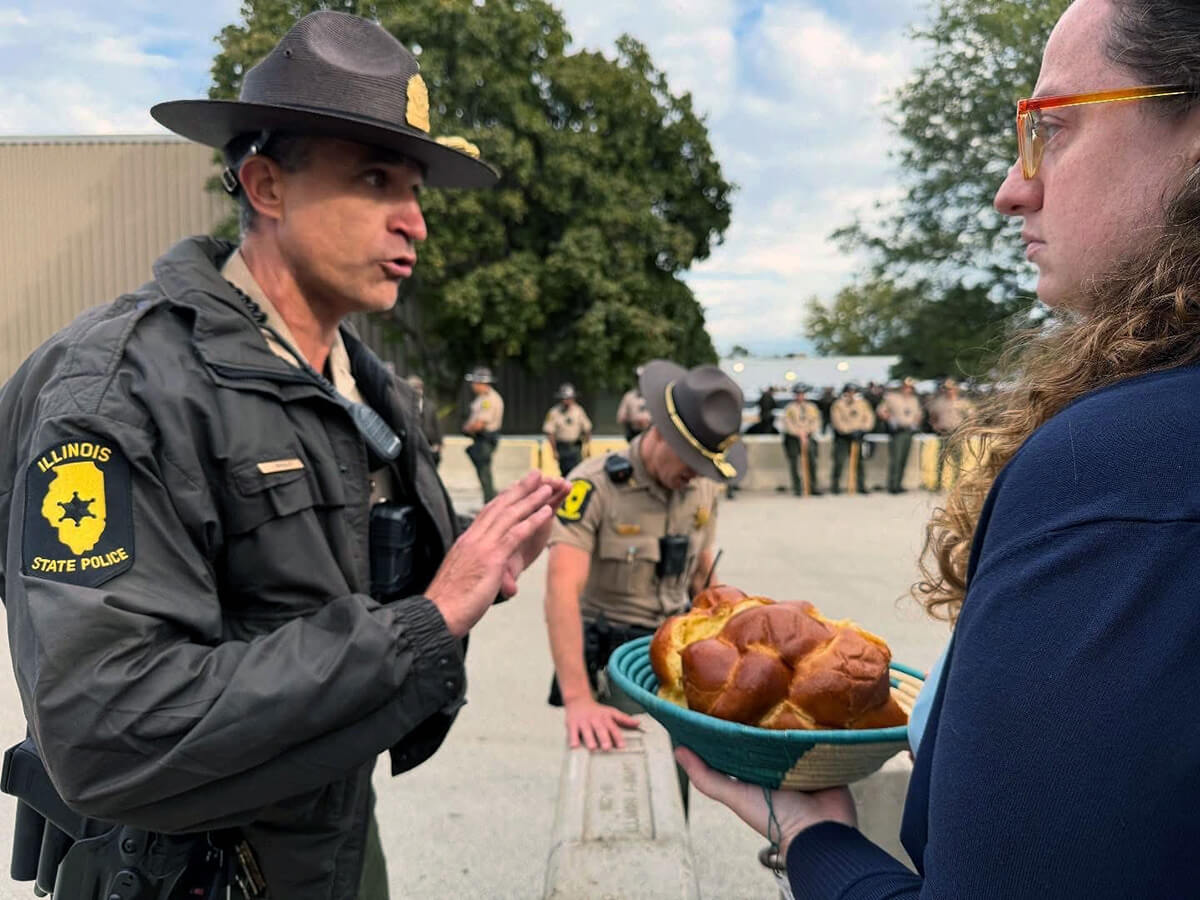 Illinois State Police Lt. Col. Jason Bradley (left) speaks with the Rev. Hannah Kardon, a United Methodist pastor who was among a group of clergy asking to bring Holy Communion to detainees in the U.S. Immigration and Customs Enforcement facility in Broadview, Ill., near Chicago. The following day another group of clergy also made the same request. Both times Bradley reached out to ICE officials, who denied the clergy entry. Photo by the Rev. Britt Cox, First United Methodist Church in Evanston, Ill.