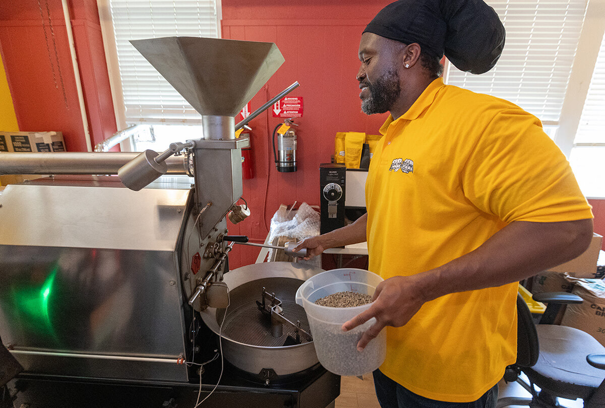 Timothy "GA" Underwood prepares to roast coffee at the Deep Time ministry. Photo by Mike DuBose, UM News.