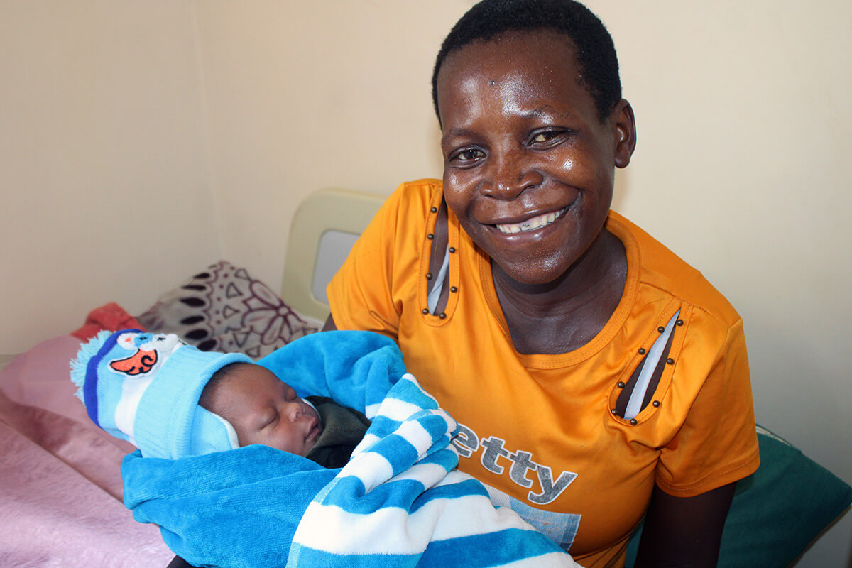 Sarah Mushamba holds her baby, Clarence Rinomhota, at the newly renovated Chindenga rural health clinic in Mutoko, Zimbabwe. The center is the final clinic under the United Methodist Nyadire Mission Hospital to be renovated. Photo by Kudzai Chingwe, UM News. 