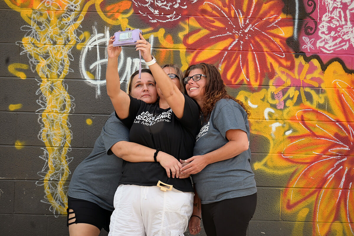 Members of Second Chance take a selfie in the courtyard of Franklinton High School in Columbus, Ohio. Second Chance is a new United Methodist faith community focused on people recovering from addictions. It frequently worships in the building, which previously housed a United Methodist church. Photo by Jim Patterson, UM News.