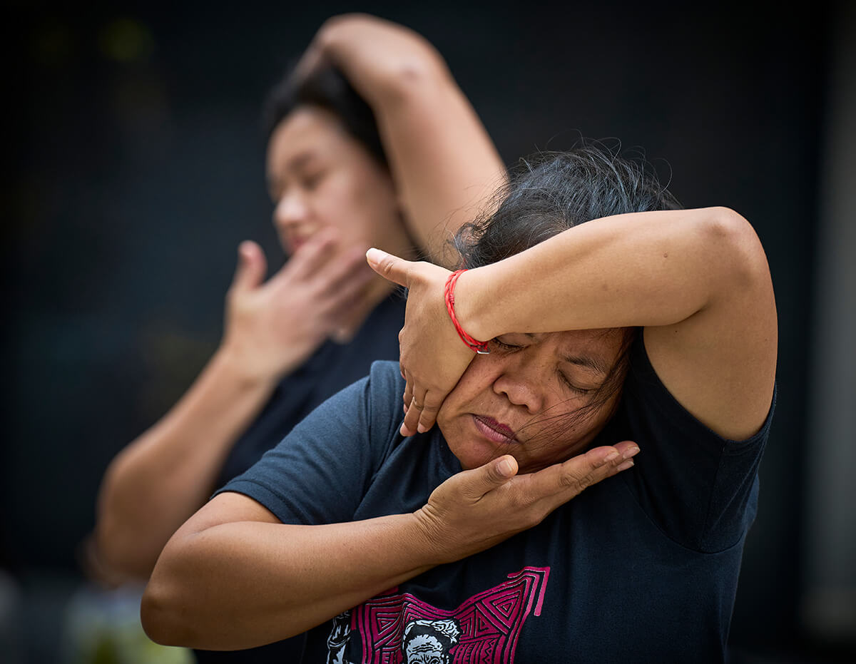 Jovie Cantre (front) and another migrant worker from the Philippines dance in the streets of Hong Kong on a Sunday when they gather along Chater Road to relax, eat and visit with their friends. Cantre has worked in Hong Kong since 2009, and has become an activist for workers’ rights. Photo by Paul Jeffrey, UM News.