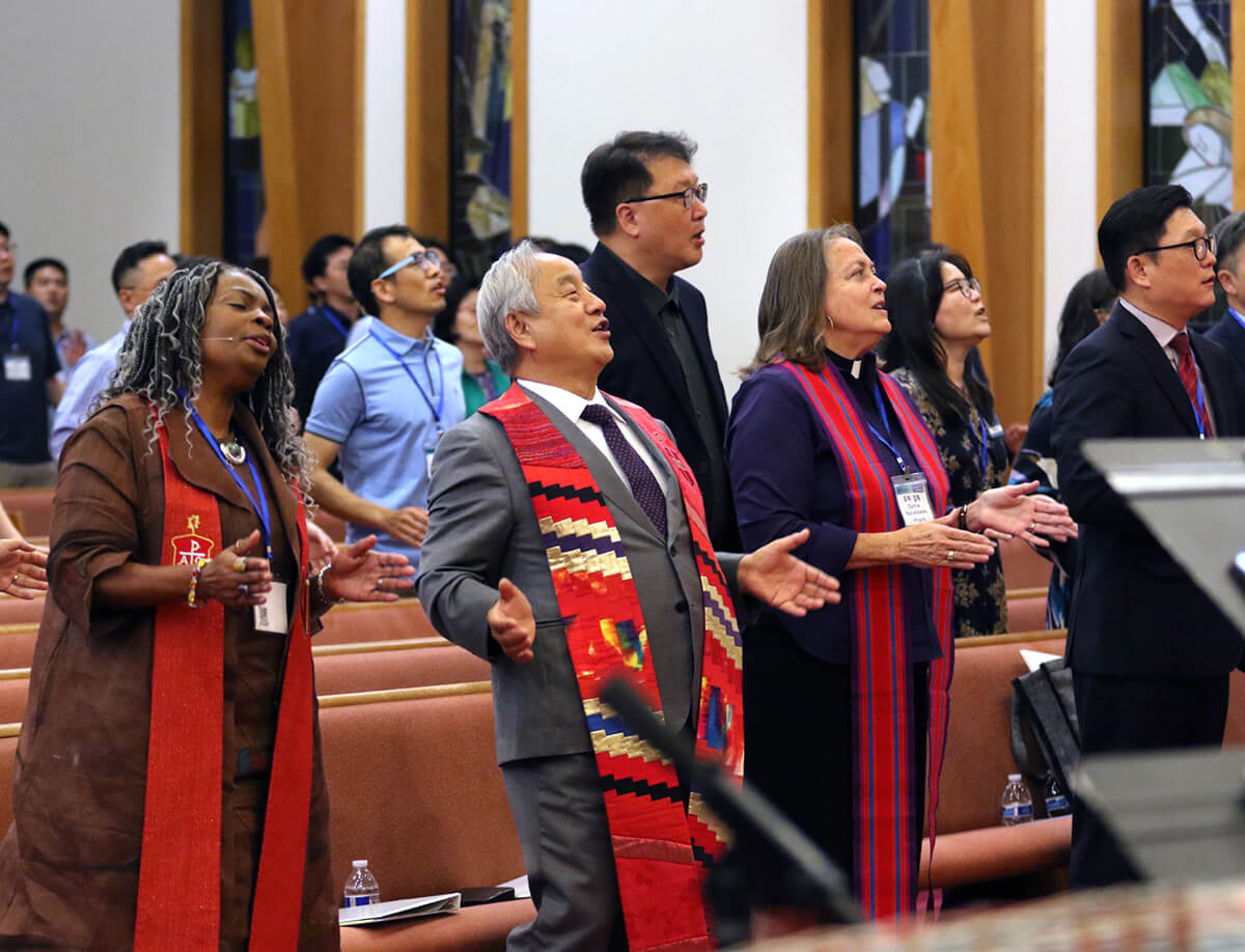 Participants sing praises during the opening worship of the Korean Association of The United Methodist Church, held at Calvary Korean United Methodist Church in East Brunswick, N.J.  From left are Bishops Cynthia Moore-Koikoi of the Greater New Jersey and Eastern Pennsylvania conferences; Hee-Soo Jung of the Ohio Episcopal Area; Dottie Escobedo-Frank of the California-Pacific Conference; and the Rev. Kyu Hyun Kim, pastor of Berkeley Korean United Methodist Church in Orinda, Calif. Photo by the Rev. Thomas E. Kim, UM News.
