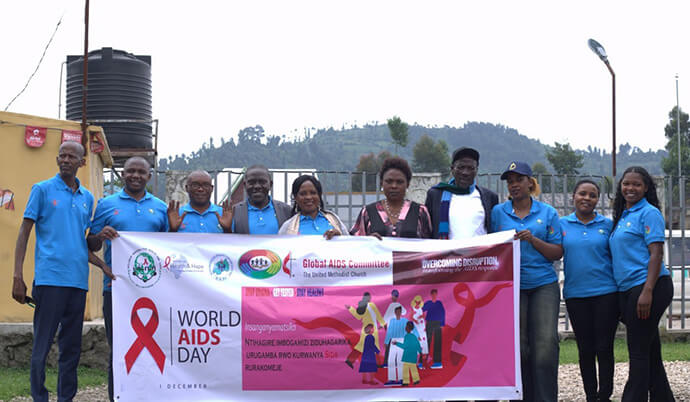 Leaders of various organizations in the Mukamira area join together in helping to prevent the spread of HIV at a World AIDS Day event. The gathering, organized by Inclusive Mission for Health and Hope, a United Methodist ministry, marked the first time United Methodists and Rwandan government officials publicly joined together to fight AIDS. Photo by Samuel Iraguha Shema.