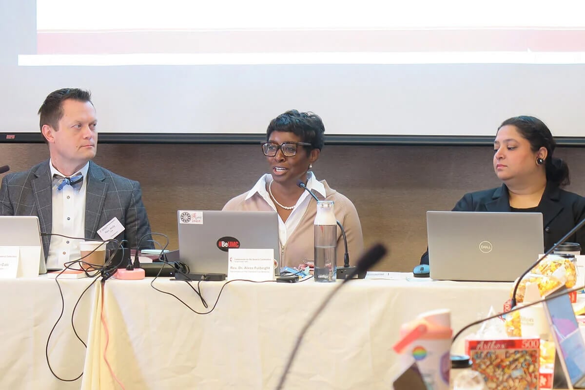 The Rev. Aleze M. Fulbright (center) celebrates the growth of The United Methodist Church in Africa as the Commission on the General Conference meets in Minneapolis on Nov. 11. Indiana Conference Bishop Tracy S. Malone announced Jan. 16 that Fulbright is leaving her role as General Conference secretary to become executive secretary to the bishop, starting in July. Photo by Heather Hahn, UM News.
