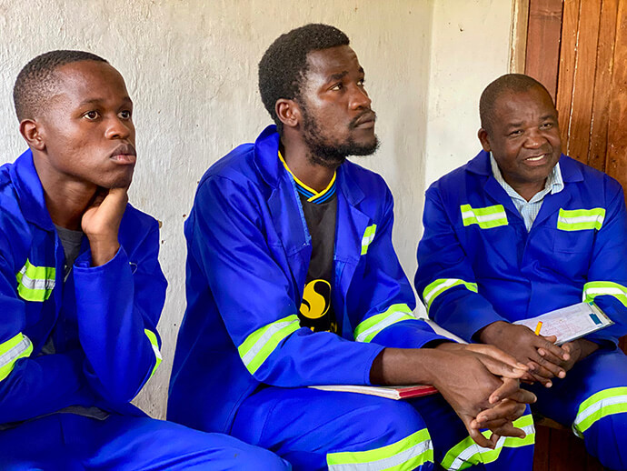 Charles Namika (right), manager of Mikundi Dairy Farm in Blantyre, Malawi, sits with Daniel Manda (middle), the farm’s finance officer, and Clement Kainga (left), unit supervisor. Staff have been working to revitalize the farm, including plans to purchase 30 dairy cows in February and complete a 7.4-hectare fenced grazing area. Photo by Francis Nkhoma, UM News.