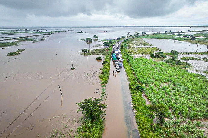 Vehicles line up on a flood-damaged road in Maputo, Mozambique, on Jan. 17. Massive flooding in the region has ruined more than 60,000 hectares of agricultural land and damaged schools, churches, hospitals, water systems, roads and power lines. (AP Photo)