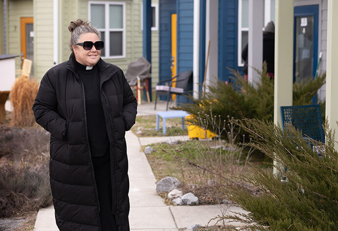 The Rev. Ingrid McIntyre walks among the tiny homes that form the Village at Glencliff, a medical respite ministry of Glencliff United Methodist Church in Nashville, Tenn. Photo by Mike DuBose, UM News.