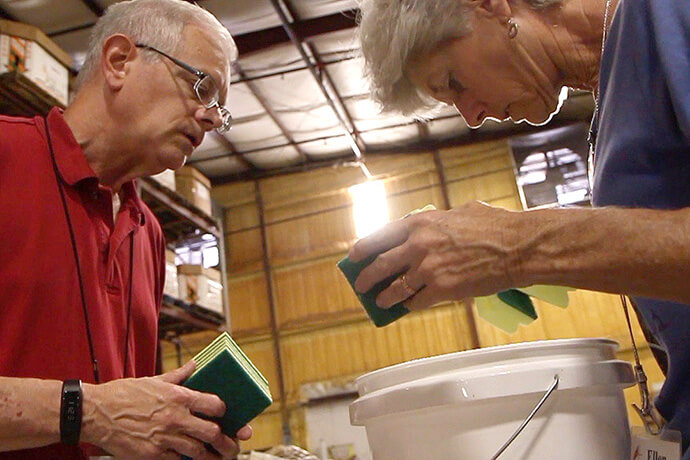 Volunteers pack a flood bucket at UMCOR’s Sager Brown Depot in Baldwin, La. The warehouse, which has been assembling relief supply kits for nearly three decades, will close in 2027, the United Methodist Committee on Relief announced on Feb. 10. Photo courtesy of the Louisiana Conference.