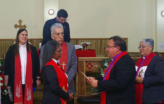 Bishop Juan de Dios Peña presents the ordination certificate to the Rev. María Magdalena Zelaya Cruz. From left are Bishop Juan Miguel Simpson Bennett, the Rev. Amy Spaur, Bishop Rubén Sáenz Jr., missionary Cristian Schlick and Bishop Lizzette Gabriel Montalvo. Photo by the Rev. Gustavo Vásquez, UM News.