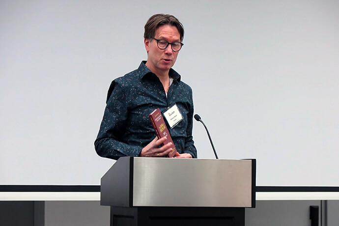 Bishop Knut Refsdal, who leads the Nordic-Baltic-Ukraine Area, shows church leaders a copy of the supplemental Book of Discipline that the then Northern Europe and Eurasia Central Conference, now regional conference, adopted last year. All the regional conferences, including the U.S., will have the authority to develop their own supplemental Discipline. Photo by Heather Hahn, UM News.