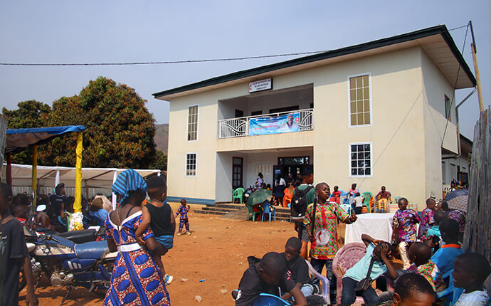 Congregants and children gather outside Bethel Cascade United Methodist Church in Bangui, Central African Republic, during an ordination service in December. Due to historic turnout for the event, many community members watched the ceremony from the courtyard of the building that serves as the headquarters for The United Methodist Church’s mission initiative in the Central African Republic. Photo by Chadrack Tambwe Londe, UM News.