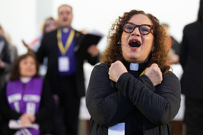 The Rev. Lydia Muñoz leads singing during worship for “Faithful Resistance: A Public Witness for Immigrant Justice” at Capitol Hill United Methodist Church in Washington. Photo by Mike DuBose, UM News.