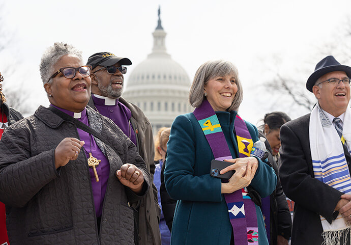 Faith leaders join in chanting near the U.S. Capitol during “Faithful Resistance: A Public Witness for Immigrant Justice,” in Washington. From left are Bishops LaTrelle Easterling and Alfred Johnson and the Rev. Erica Robinson-Johnson. Photo by Mike DuBose, UM News.