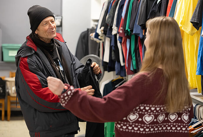 James, a client at the Clothing Restore ministry of McKendree United Methodist Church in Nashville, Tenn., picks out a shirt with the help of volunteer Abby Kiesow. Photo by Mike DuBose, UM News.