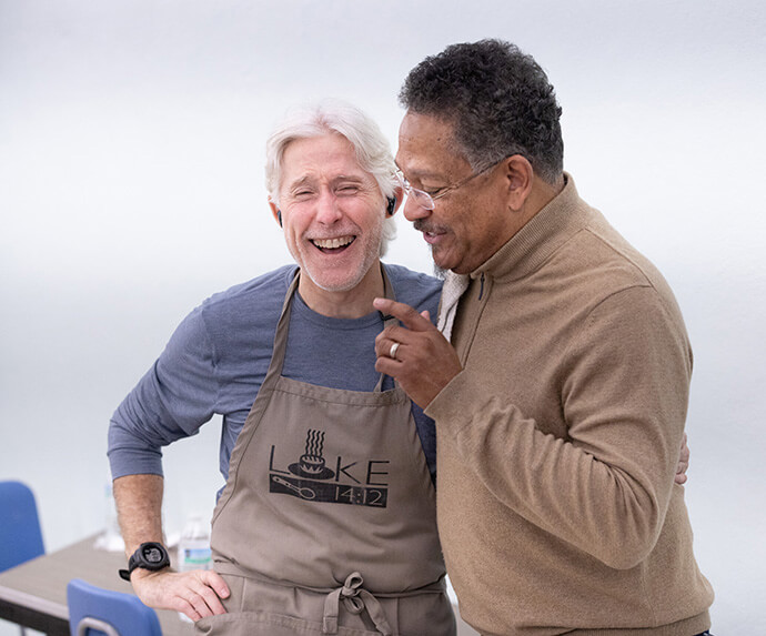 The Rev. Stephen Handy (right) shares a laugh with volunteer Chris Highfield before the twice-weekly feeding program at McKendree United Methodist Church in Nashville, Tenn. Handy is senior pastor at McKendree, and Highfield volunteers with Luke 14:12, a ministry that got its start at Edgehill United Methodist Church in Nashville. Photo by Mike DuBose, UM News.