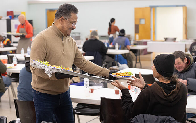 The Rev. Stephen Handy serves guests during a community meal at McKendree United Methodist Church in Nashville, Tenn. Photo by Mike DuBose, UM News.
