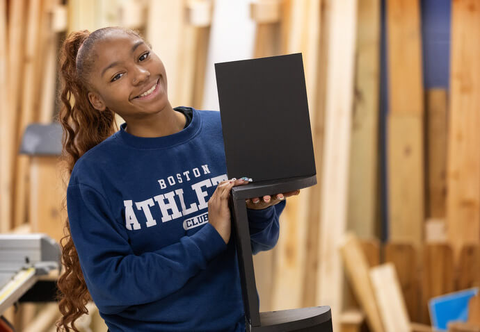 Navaeh Chairs displays the decorative shelf she made in the vocational training program of the Judge Dinkins Educational Center, housed at McKendree United Methodist Church in Nashville, Tenn. Photo by Mike DuBose, UM News.