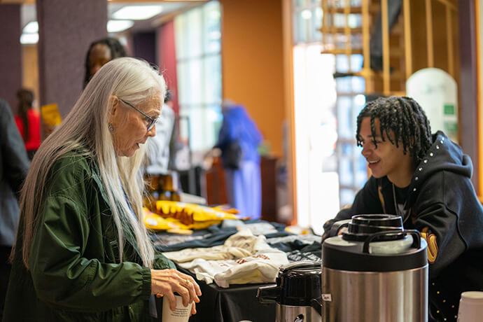 Shilone Knight (right) chats with a customer getting coffee during the Fresh Expressions United Methodist National Gathering 2026 at First United Methodist Church in Ocala, Fla. He is part of the Deep Time ministry at Trinity United Methodist Church in Asheville, N.C. The group served free coffee to people attending the conference. Photo by Brian Rose of Church of the Restoration in Reston, Va.