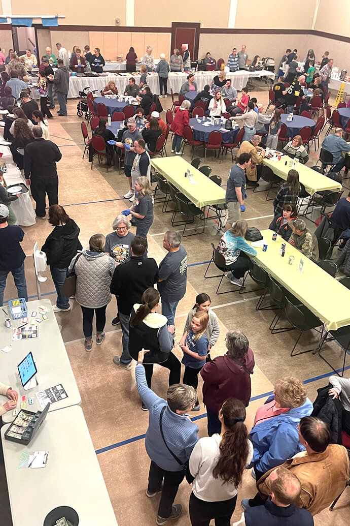 People line up for the Feb. 27 fish fry at Community United Methodist Church in Irwin, Pa. The line starts forming an hour before kickoff time for the fundraisers held Friday nights during Lent. The meal includes fried cod and a side of haluski, an Eastern European dish with cabbage and noodles. Photo by Betsy Smith.