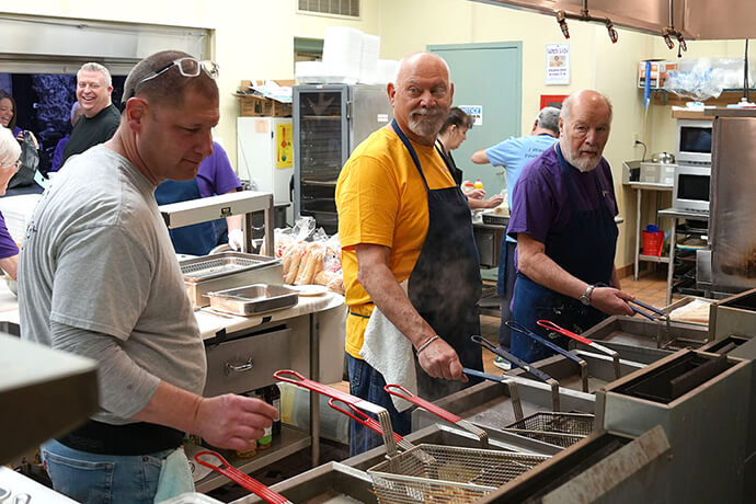 Volunteers tend to the fryers at Christ United Methodist Church in Bethel Park, Pa., during the church’s Feb. 20 Lenten fish fry. The volunteer team numbers in the 90s during the annual Friday night fish fries. The church takes in as much as $100,000 every year, with lunch and dinner served on the six Fridays leading to Holy Week. Photo by Sean Lewis.
