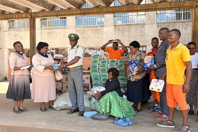 Pastors from Chitungwiza Marondera District unpack basic goods they donated to Chikurubi Maximum Security Prison.  The prison is home to men serving minimum 10-year sentences.  Photo by Eveline Chikwanah, UM News.
