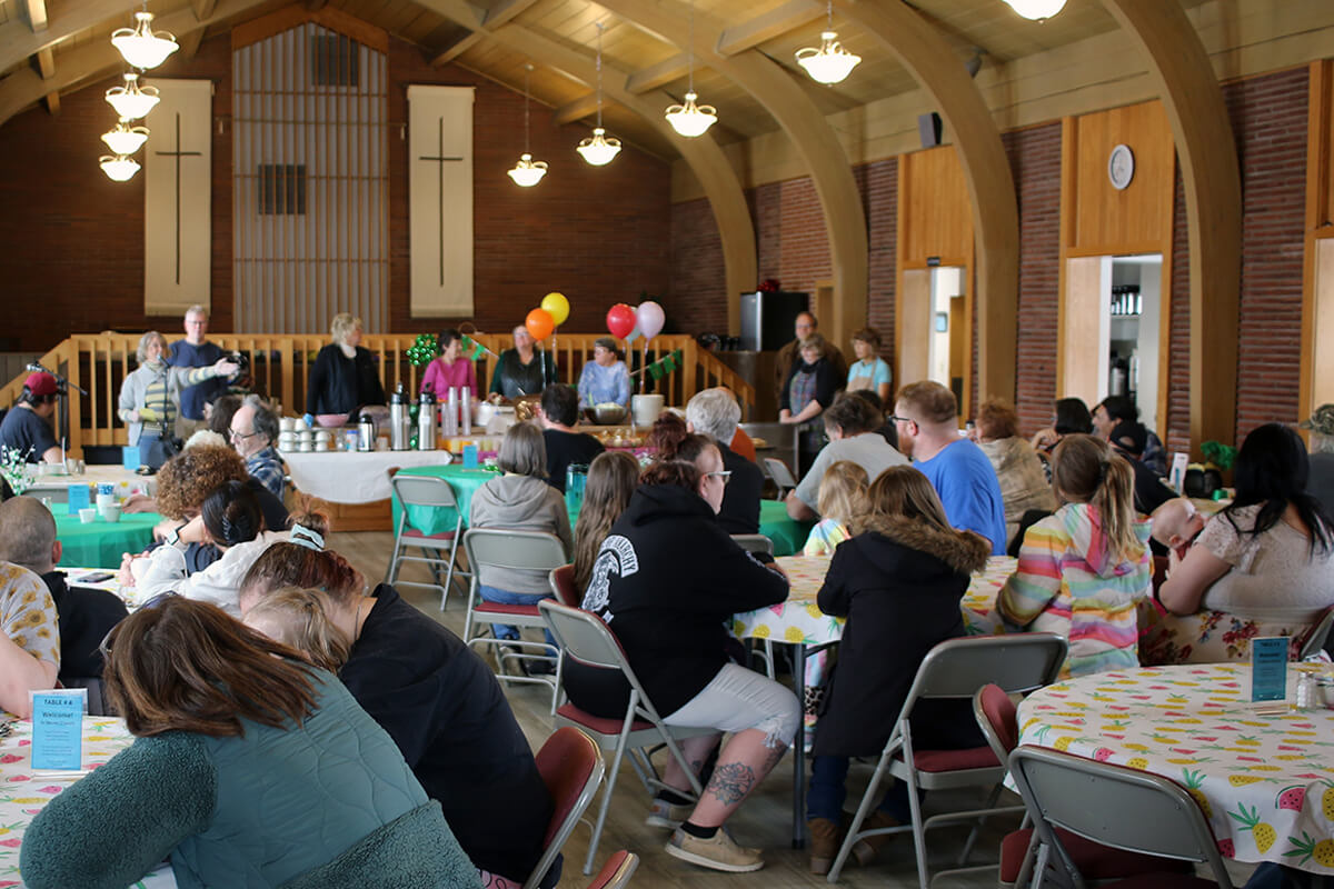 Members of Black River Falls United Methodist and community guests enjoy  “Dinner Church” on March 18 at the rural Wisconsin church. The weekly ministry, which is celebrating its second anniversary, has become a place where strangers become friends and a small congregation reimagines its mission. Photo by the Rev. Thomas E. Kim, UM News. 